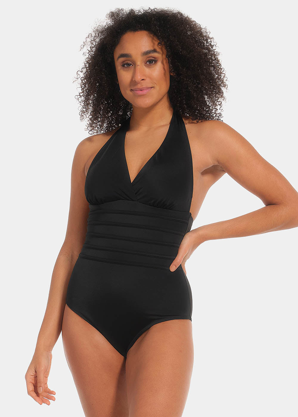 Woman wearing a black swimsuit against a white background