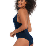 Woman wearing a navy blue one-piece swimsuit on a white background