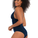 Woman wearing a navy blue one-piece swimsuit on a white background