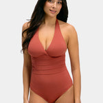 Woman wearing a sunset colored swimsuit on a white background