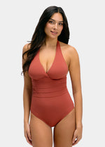 Woman wearing a sunset colored swimsuit on a white background