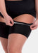 A person wearing black thigh bands with silicone trim to prevent rolling and chaving.