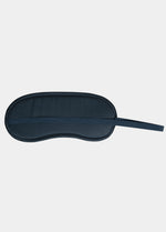 Navy blue sleep mask on a light gray background