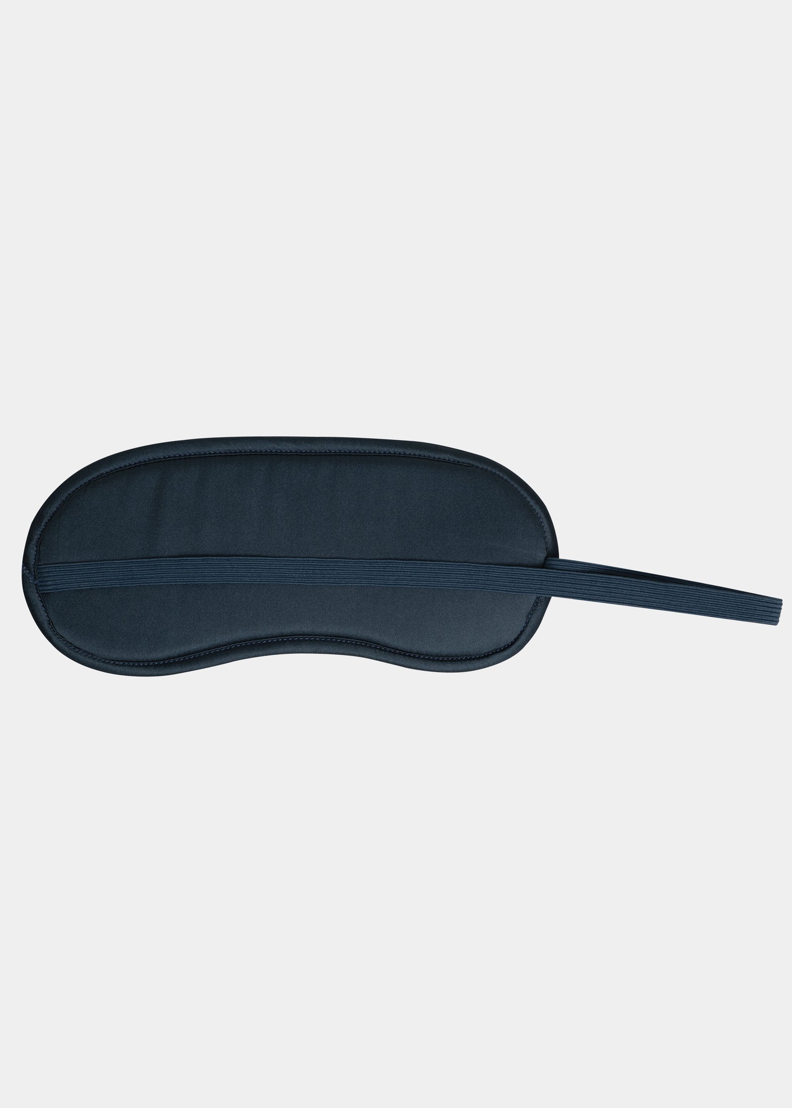 Navy blue sleep mask on a light gray background