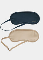Two sleep masks, one navy and one beige, on a light gray background.