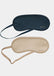 Two sleep masks, one navy and one beige, on a light gray background.