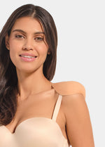 Woman wearing a beige strapless top with a shoulderpad against a plain background