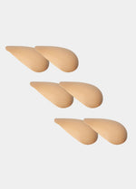 Set of beige shoulderpads on a light gray background