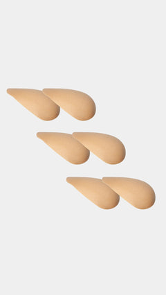 Set of beige shoulderpads on a light gray background